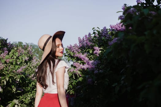 A fashionable girl with dark hair, a spring portrait in lilac tones in summer. Bright professional makeup