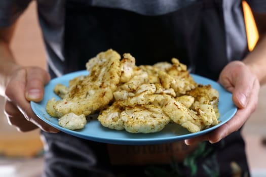 Roasted cauliflower steak. Vegetable meat substitute. Tasty vegetarian food. Selective focus