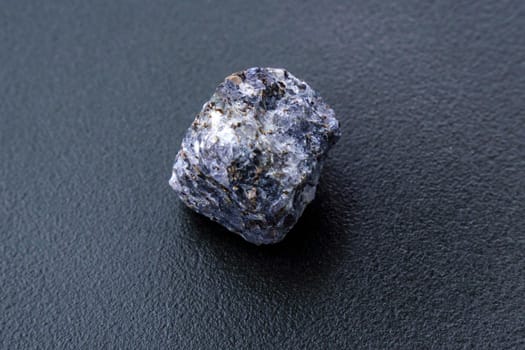 Crystal of cordierite iolite gem stone cutout, raw mineral, black background
