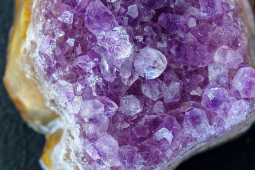 Crystal stone is a mineral. Purple rough amethyst quartz crystals, close up macro