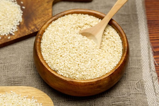Healthy food and drink concept. Sesame seeds in a bowl on a rustic table. Selective focus