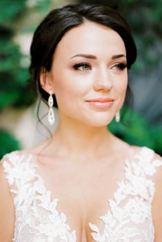 Portrait of a bride in a white lace dress with embroidery. High quality photo