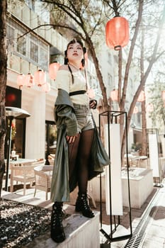 Full length portrait of Asian woman in front of Chinese lanterns