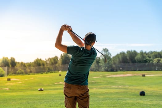 Golf hit in a wide golf course in summer. Young male playing. High quality photo