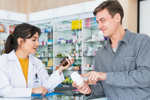 Professional pharmacist advise or explain property of qualified medical product to customer in pharmacy, druggist answer to client healthcare inquiry, medical service and consultation concept.