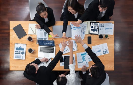 Top-view business team of financial data analysis meeting with business intelligence, report paper and dashboard on laptop for marketing strategy. Business people working together in office of harmony