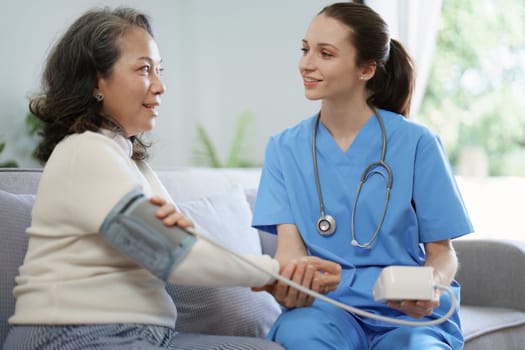 Portrait of female doctor measuring patient's blood pressure before treatment