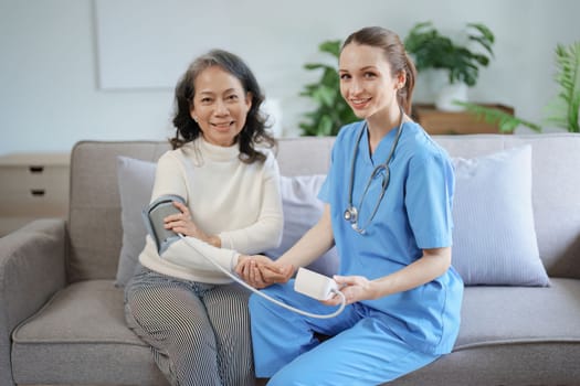 Portrait of female doctor measuring patient's blood pressure before treatment