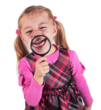 Funny girl showing teeth through a magnifying glass, isolated on white