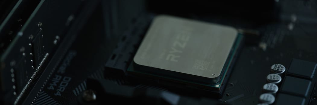 Tbilisi, Georgia - July 26, 2022: Closeup of AMD Ryzen processor motherboard. High performance microprocessor introduced by AMD