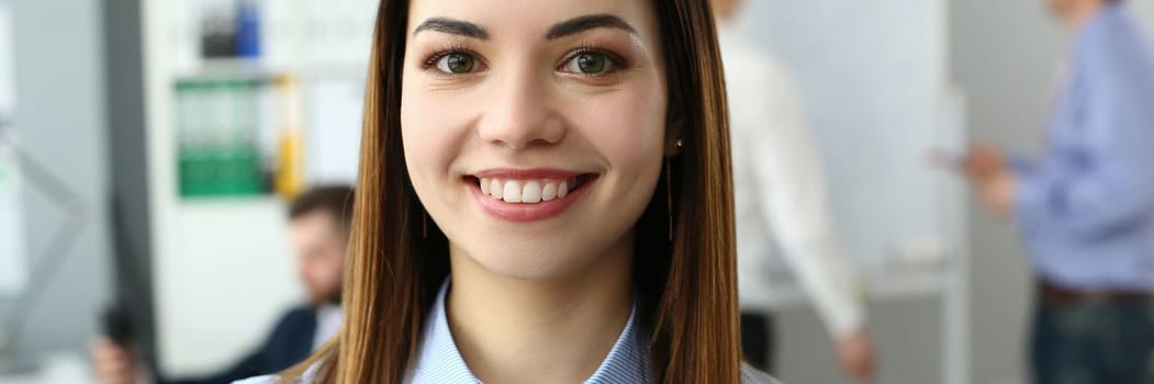 Portrait of a beautiful woman on background of business people. Young ambitious business woman to build career in consulting company