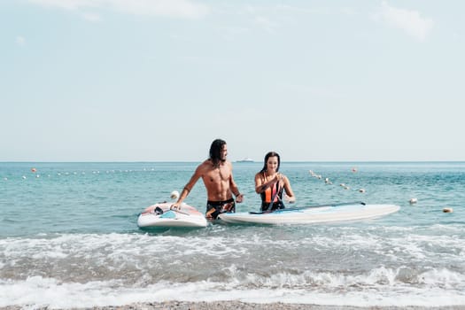 Woman man sea sup. Close up portrait of beautiful young caucasian woman with black hair and freckles looking at camera and smiling. Cute woman portrait in a pink bikini posing on sup board in the sea