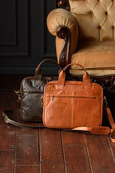 close-up photo of orange and brown leather bags corporate. Indoor photo