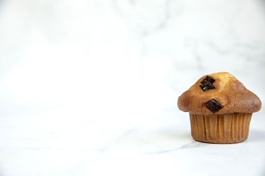 A stack of delicious chocolatechip banana muffins and blueberries on a white background, tasty healthy snack granola breakfast muffin food