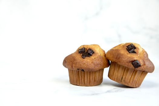 A stack of delicious chocolatechip banana muffins and blueberries on a white background, tasty healthy snack granola breakfast muffin food