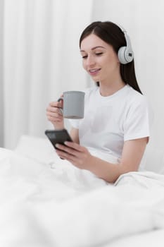 Portrait of Good Healthy woman drinking tea and resting in bed at bedroom. Lifestyle at home concept.