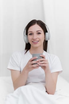 Portrait of Good Healthy woman drinking tea and resting in bed at bedroom. Lifestyle at home concept.