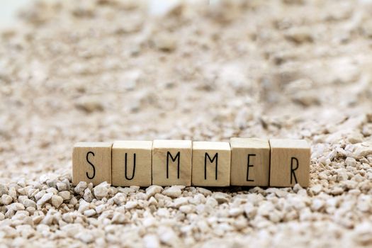 Word Summer on beach, Sand texture background. tropical Holiday concept copy space, close up
