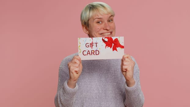 Young woman showing banner sign love like, comment, share. Girl social media blogger waiting for online followers feedback and positive rate on internet on pink background. Lgbt gay lesbian people