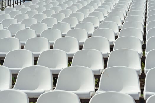 Seats of tribune on sport stadium. Concept of fans, chairs for audience, cultural environment concept. mpty seats, modern stadium