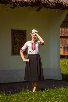 young woman in ukrainian national costume outdoors