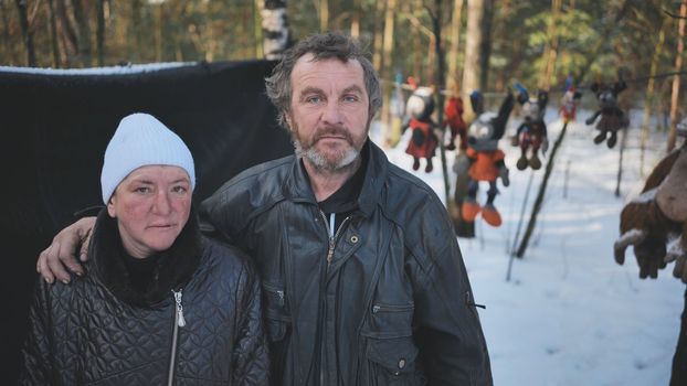 Homeless people are interviewed in the winter in the woods