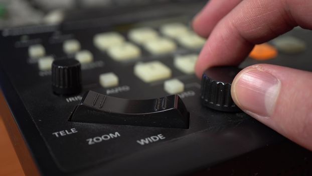 A man sets up remotely controlled cameras. Camera control panel. Hand close up. 4k