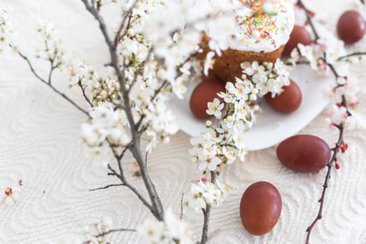 Traditional Easter cakes and colored eggs. A branch tree.