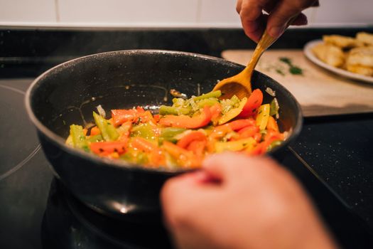 A Taste of Grandmas Kitchen. Sauteed Peppers and Onions by an Elderly Chef.