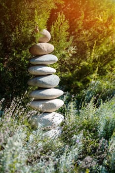 Balance stones are arranged in a pyramid shape,Stone Stacked on green nature background
