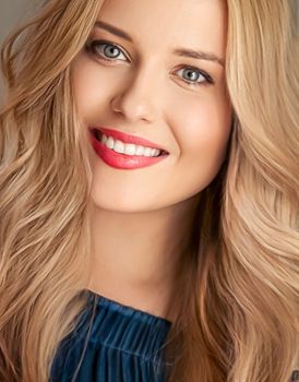 Beauty and femininity, beautiful blonde woman with long blond hair smiling, natural portrait closeup