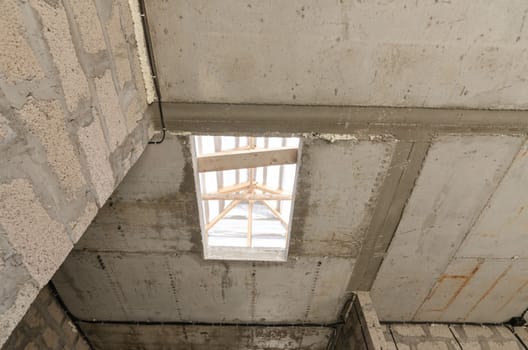 Construction of an individual residential building, an opening in monolithic reinforced concrete floors for stairs to the second floor a