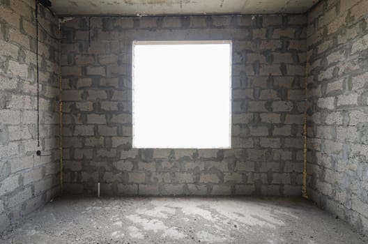 Construction of an individual residential building, view of a square window opening on the wall a