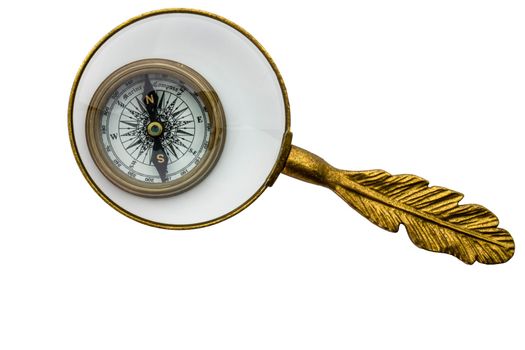 Vintage look compass under magnifying glass, glass has feather look gold handle, concept of examining direction in life. Clipping path. High quality photo