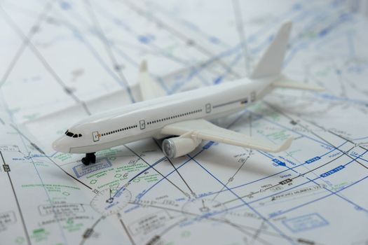 Close up of airplane on an FAA sectional chart navigation aid with background blur, selective focus. Concept of air traffic control safety. High quality photo