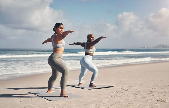 Yoga is an art that you need to practice daily. two young women practicing yoga on the beach