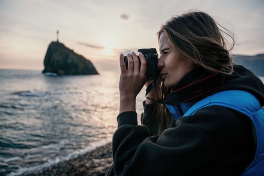 Woman travel sea. Happy tourist taking picture outdoors for memories. Woman traveler looks at the edge of the cliff on the sea bay of mountains, sharing travel adventure journey.