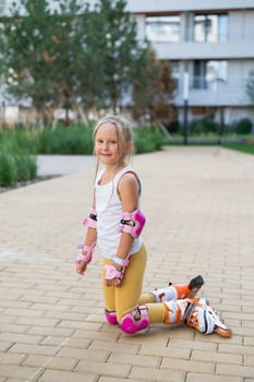 A little girl and her mom do a bridge exercise at the outdoor sports ground