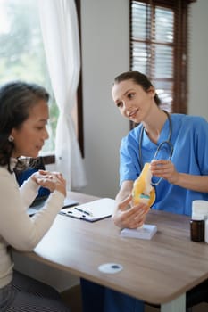 Portrait of a female doctor talking to an elderly patient about osteoarthritis