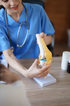 Portrait of a female doctor talking to an elderly patient about osteoarthritis