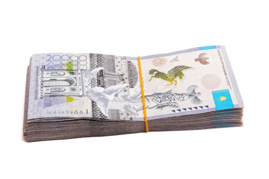 Side view of Bundle of Kazakhstan banknotes of 20000 tenge tied with an elastic band, isolated on white.