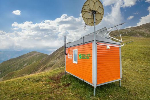 Self-contained rescue hut with solar panels and satellite connection for hikers on top of Almaty mountains. Almaty, Kazakhstan - July 19, 2022