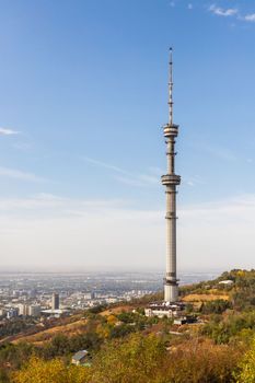 Vertical view from the Kok Tobe mountain with a TV tower to the city of Almaty. Almaty, Kazakhstan - September 28, 2022