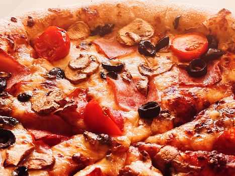 Pizza capriciosa in pizzeria, food background close-up