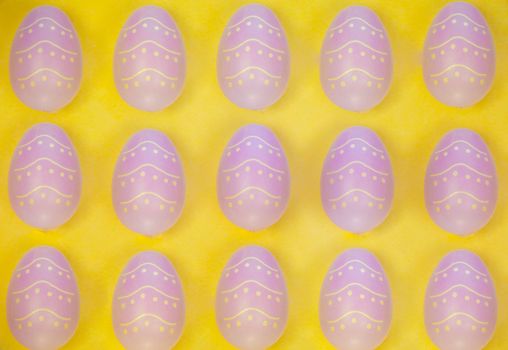 Easter banner with colorful Easter Egg in a row. Border over a yellow background. Above view with copy space. Easter decorated eggs frame. Happy Easter card. Top view, flatlay. colorful background