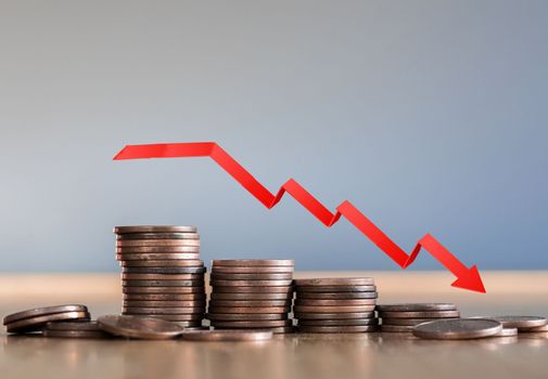 Inflation. The recession of the economy and the euro. The concept of economic collapse and the collapse of the stock exchange in the euro zone. Stacks of coins and a graph arrow pointing down. recession