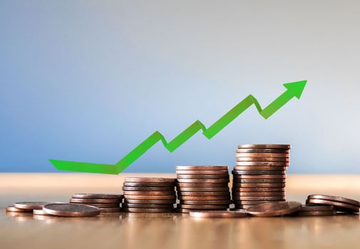 Growth graph and green arrow up. A symbol of successful investment and accumulation of money. Business and financial, savings concept copy space close up