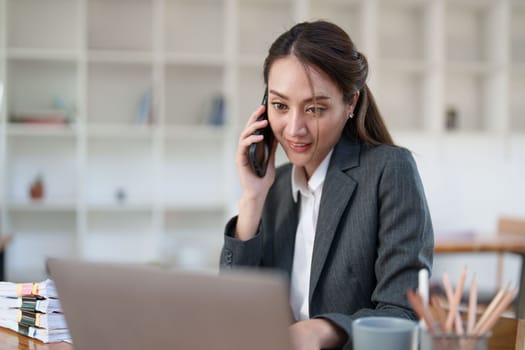 Beautiful business woman talking on the mobile phone. Management, planning and networking phone call concept