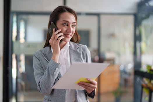 Beautiful business woman talking on the mobile phone. Management, planning and networking phone call concept