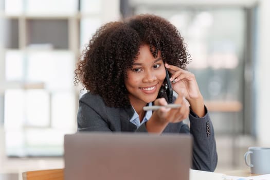 American african business woman talking on the mobile phone. Management, planning and networking phone call concept